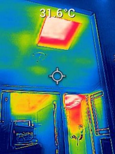 An image from a thermal imaging camera showing the heat from a skylight and uninsulated ceiling.